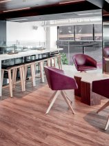 A bright and airy meeting space with four chairs positioned around a small desk