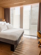 View of bed, desk, chair and window