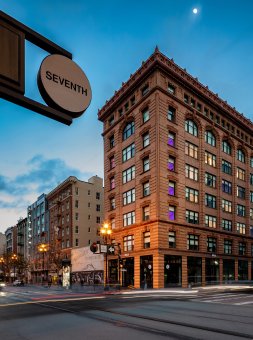 A picturesque old building, a YOTEL, in San Francisco's Tenderloin area at night