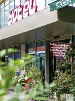 A leafy view of the exterior of YOTEL Manchester Deansgate