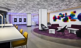 YOTEL lobby with check-in kiosks, seating area and colourful art mural on the wall