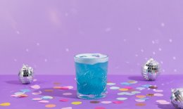 Blue cocktail with discoballs in the background