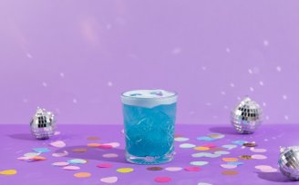 Blue cocktail with discoballs in the background