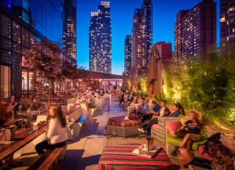 YOTEL New York terrace and bar filled with guests in the evening