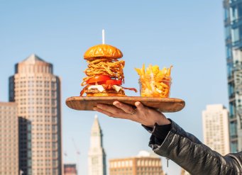YOTEL Boston burger and fries with the Boston skyline