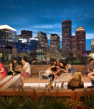 YOTEL Boston - Deck 12 rooftop bar at night filled with guests