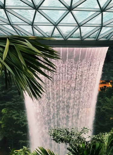 A huge rain vortex pours down in an indoor display at Singapore Changi Airport