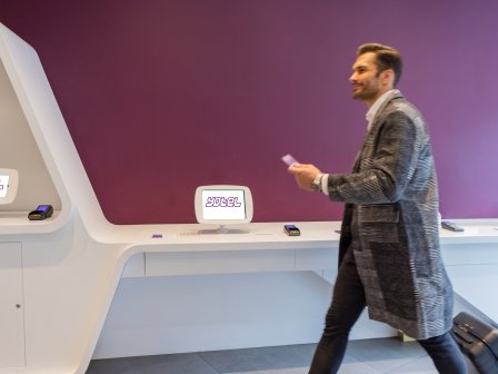 Man walking past check in kiosks