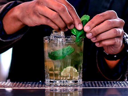 Barman fixing cocktail