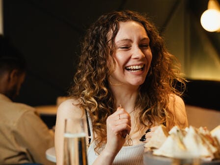 Happy woman with afternoon tea 