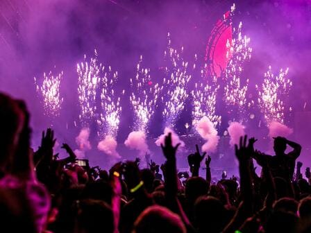 Fireworks, smoke, and purple lights at a packed-out concert in Manchester
