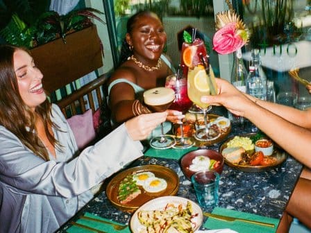 People toasting with breakfast foods