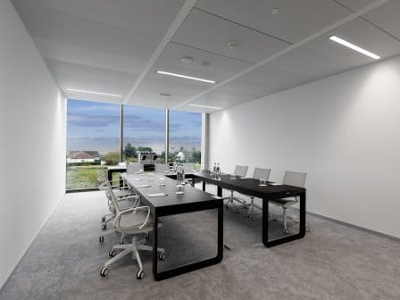 Meeting room set up with table in horse-shoe shape