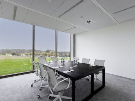 Meeting room with board room table in middle