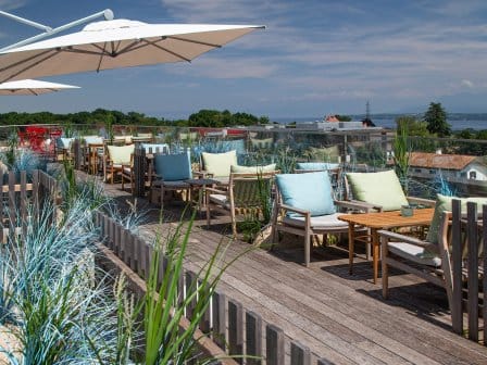 landscape of view of roof terrace with chairs and an open parasol
