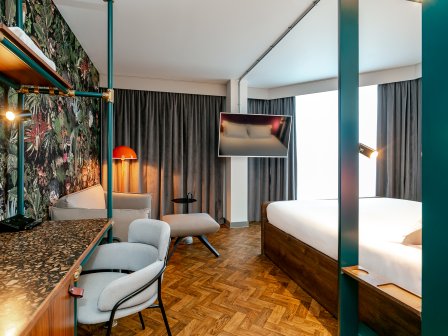 View of room with deck and side of bed 