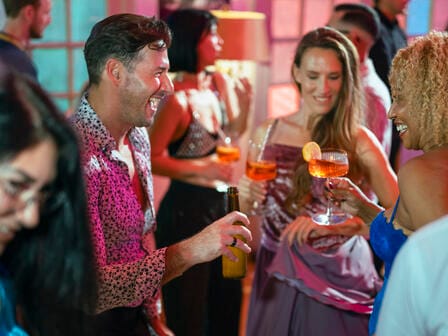Group of people with drinks socialising