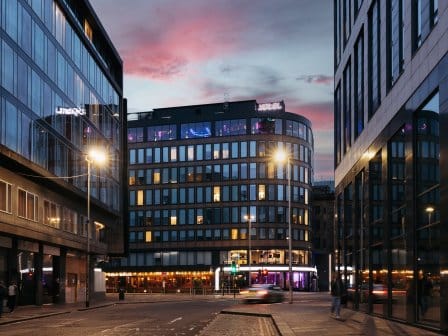 Exterior view of a modern glass building at dusk 
