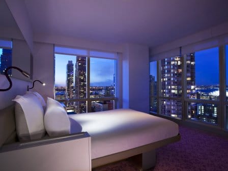 A high-rise hotel room with panoramic views of New York