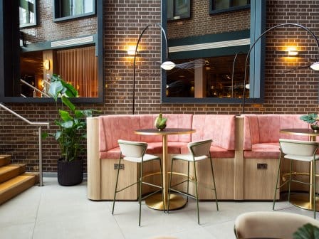 A trendy cafe or bar with pink cushions 