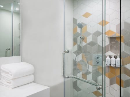 A clean shower with fluffy folded towels