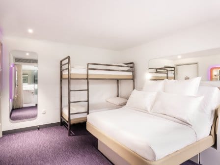 A large hotel room with a flatscreen TV