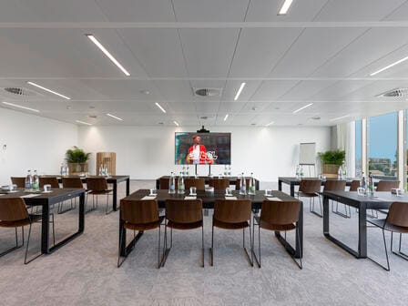 A large airy meeting space with a flatscreen TV
