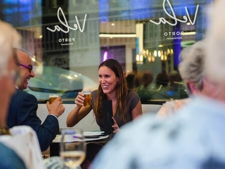 Woman and man drinking beer and smiling