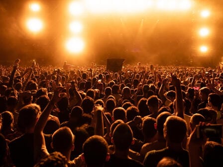 Backlit audience looking at concert stage