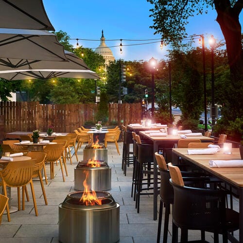 Art and Soul patio at night with fire lanterns