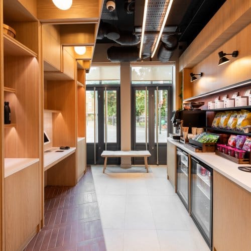 An airy self-service breakfast area with kiosks stacked with snacks and drinks