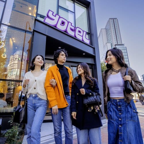 Four friends stand outside Tokyo Yotel