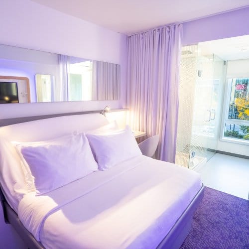 A modern room with large windows and a smartbed
