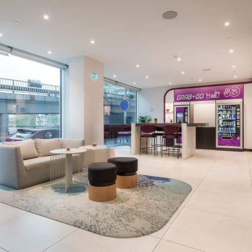 Light and spacious hotel entrance with blue and purple accents 