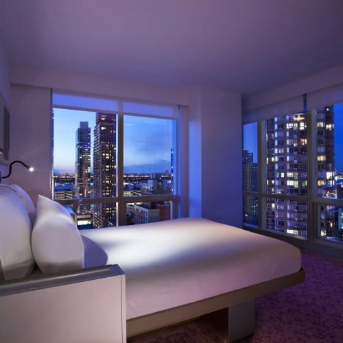 A high-rise hotel room with panoramic views of New York