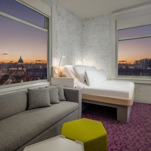 A clean hotel room with a panoramic view of san francisco