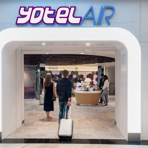 A man walks into the entrance of YOTELAIR