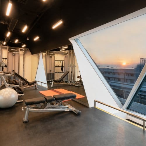 An airport hotel gym at sunset