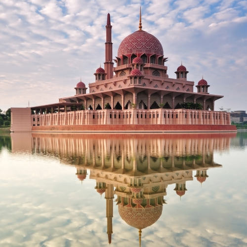 Sky reflecting on the water with a temple in Kuala Lumpur