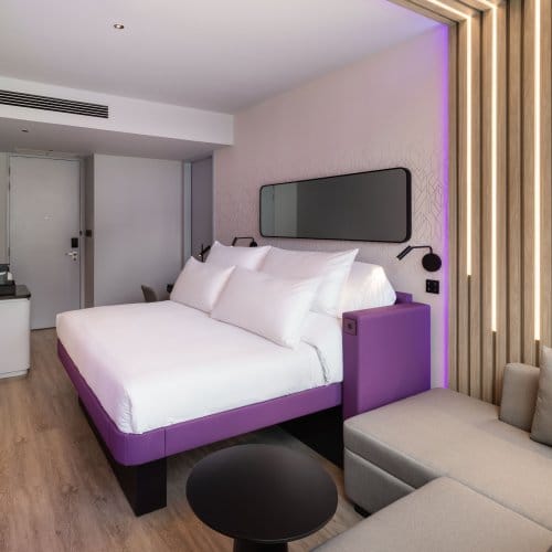 King size bed with sofa in foreground