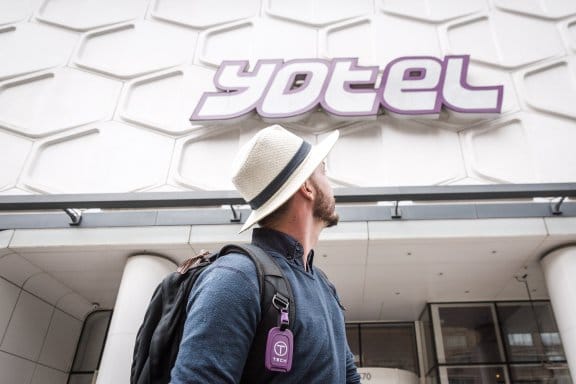 YOTEL - Guest looking up at the YOTEL New York entrance sign
