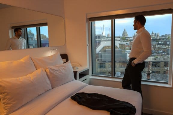 Man looking out of room window at St Pauls