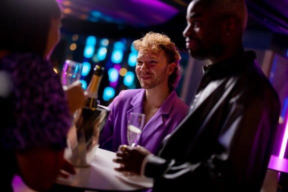Group of friends with prosecco bottle 