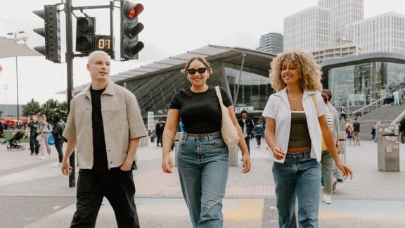 Three people walking away from Stratford Station