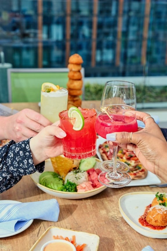 People holding up drinks