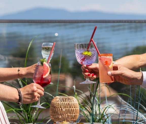 Rooftop scene with people holding cocktails