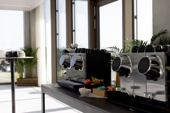 close up of two coffee machines on a table