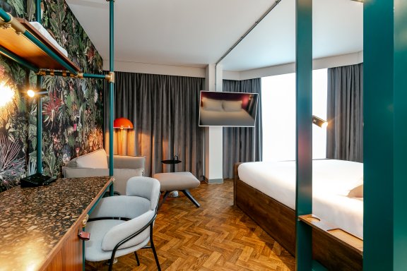 View of room with deck and side of bed 