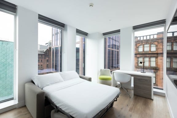 Hotel room with large windows and desk