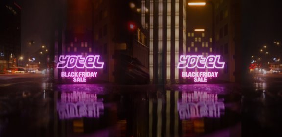 Two neon YOTEL signs in a futuristic city